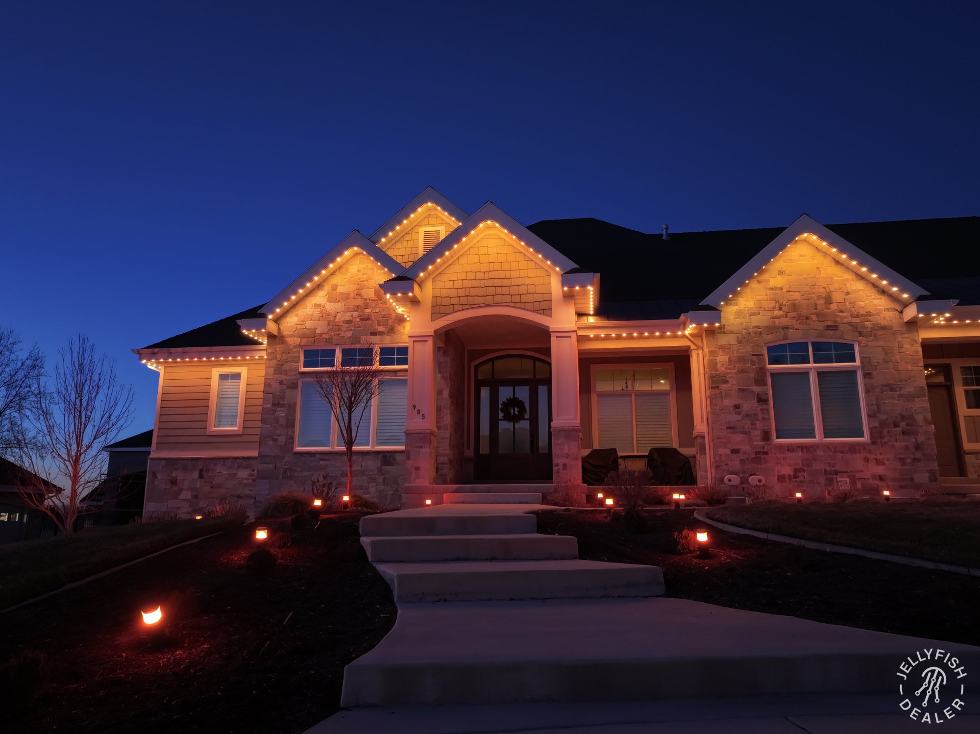 Home with warm pathway and perimeter lights